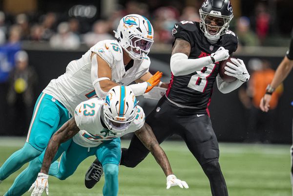 Oct 26, 2025; Atlanta, Georgia, USA; Atlanta Falcons tight end Kyle Pitts Sr. (8) is knocked out of bounds by Miami Dolphins linebacker Jaelan Phillips (15) and cornerback Jack Jones (23) during the first half at Mercedes-Benz Stadium. Mandatory Credit: Dale Zanine-Imagn Images