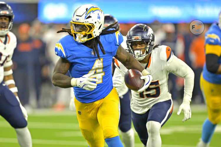 Dec 19, 2024; Inglewood, California, USA;  Los Angeles Chargers running back Gus Edwards (4) runs for a touchdown in the second half against the Denver Broncos at SoFi Stadium. Credit: Jayne Kamin-Oncea-Imagn Images