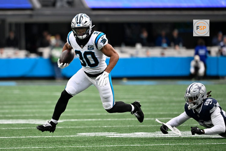 Dec 15, 2024; Charlotte, North Carolina, USA;  Carolina Panthers running back Chuba Hubbard (30) with the ball as Dallas Cowboys safety Malik Hooker (28) defends in the first quarter at Bank of America Stadium. Credit: Bob Donnan-Imagn Images