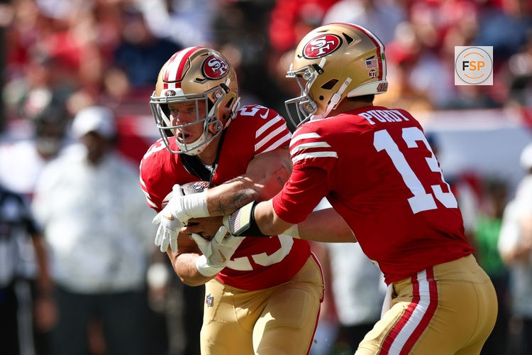 Nov 10, 2024; Tampa, Florida, USA; San Francisco 49ers quarterback Brock Purdy (13) hands off to running back Christian McCaffrey (23) against the Tampa Bay Buccaneers in the first quarter at Raymond James Stadium. Credit: Nathan Ray Seebeck-Imagn Images
