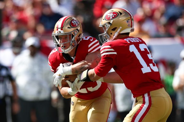 Nov 10, 2024; Tampa, Florida, USA; San Francisco 49ers quarterback Brock Purdy (13) hands off to running back Christian McCaffrey (23) against the Tampa Bay Buccaneers in the first quarter at Raymond James Stadium. Mandatory Credit: Nathan Ray Seebeck-Imagn Images