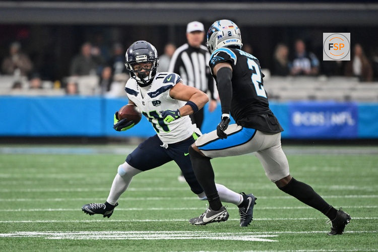 Dec 28, 2025; Charlotte, North Carolina, USA; Seattle Seahawks wide receiver Jaxon Smith-Njigba (11) runs after the catch against Carolina Panthers cornerback Mike Jackson (2) during the first quarter at Bank of America Stadium. Credit: Bob Donnan-Imagn Images