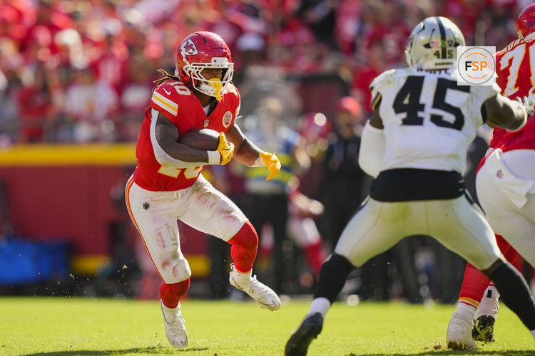 Oct 19, 2025; Kansas City, Missouri, USA; Kansas City Chiefs running back Isiah Pacheco (10) runs the ball against Las Vegas Raiders linebacker Devin White (45) during the second half at GEHA Field at Arrowhead Stadium. Credit: Jay Biggerstaff-Imagn Images