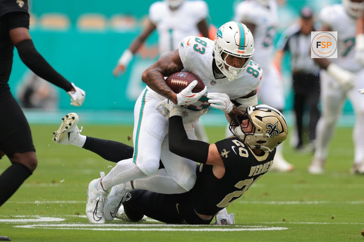 Nov 30, 2025; Miami Gardens, Florida, USA; Miami Dolphins tight end Darren Waller (83) is tackled by New Orleans Saints linebacker Pete Werner (20) during the first half at Hard Rock Stadium. Credit: Sam Navarro-Imagn Images