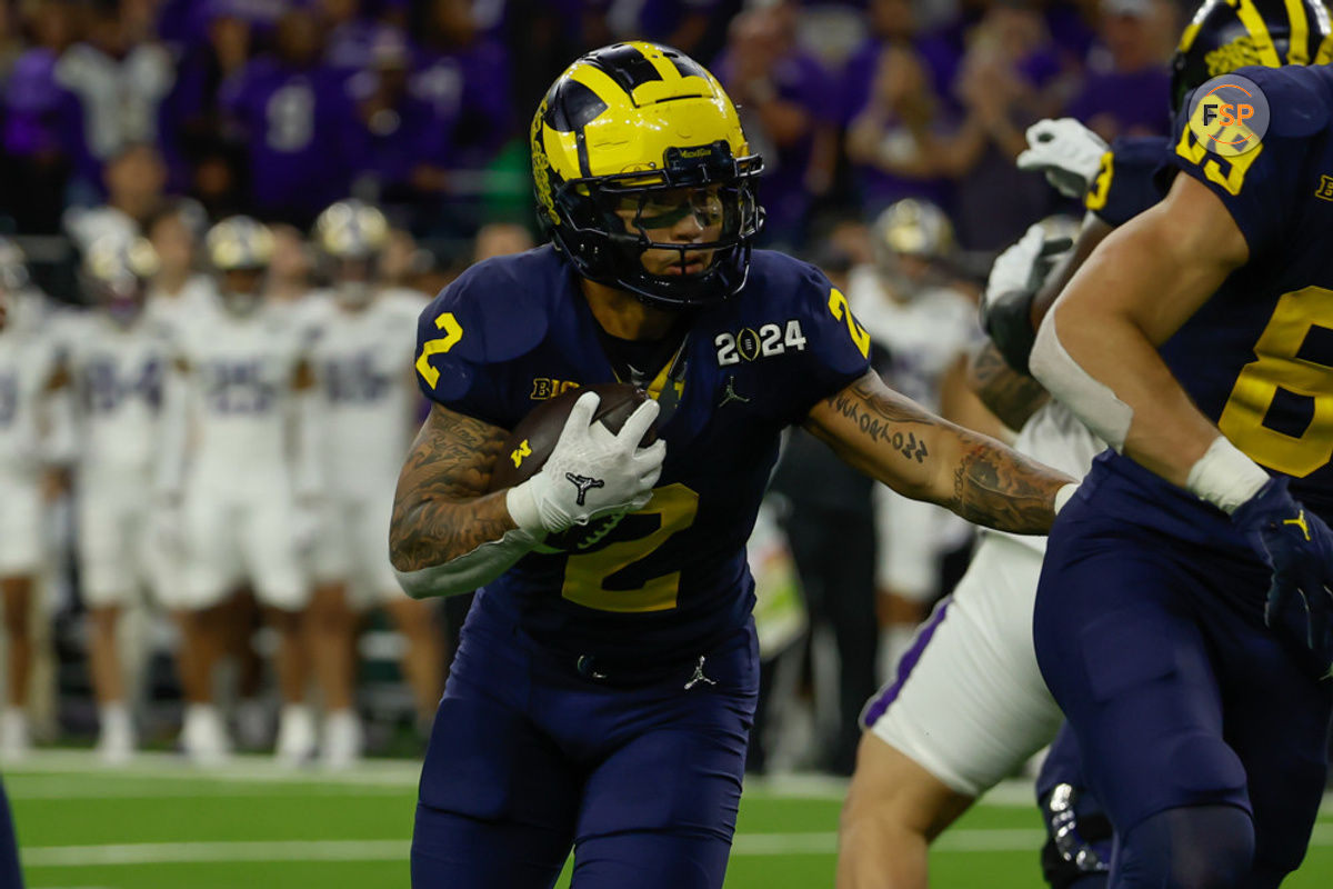 HOUSTON, TX - JANUARY 08: Michigan Wolverines running back Blake Corum (2) runs and looks for a gap in the line during the CFP National Championship game Michigan Wolverines and Washington Huskies on January 8, 2024, at NRG Stadium in Houston, Texas. (Photo by David Buono/Icon Sportswire)