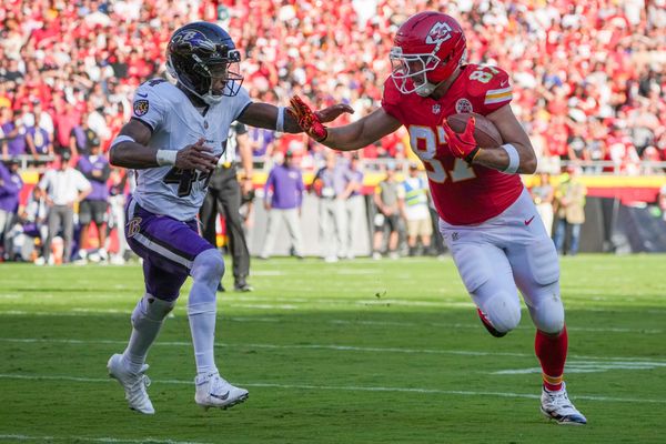 Sep 28, 2025; Kansas City, Missouri, USA; Kansas City Chiefs tight end Travis Kelce (87) runs the ball as Baltimore Ravens cornerback Marlon Humphrey (44) defends during the game at GEHA Field at Arrowhead Stadium. Mandatory Credit: Denny Medley-Imagn Images