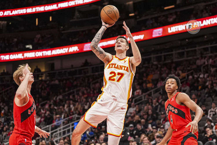 Jan 25, 2025; Atlanta, Georgia, USA; Atlanta Hawks guard Vit Krejci (27) shoots in front of Toronto Raptors guard Gradey Dick (1) during the first half at State Farm Arena. Credit: Dale Zanine-Imagn Images