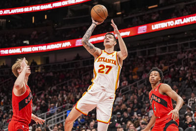 Jan 25, 2025; Atlanta, Georgia, USA; Atlanta Hawks guard Vit Krejci (27) shoots in front of Toronto Raptors guard Gradey Dick (1) during the first half at State Farm Arena. Mandatory Credit: Dale Zanine-Imagn Images