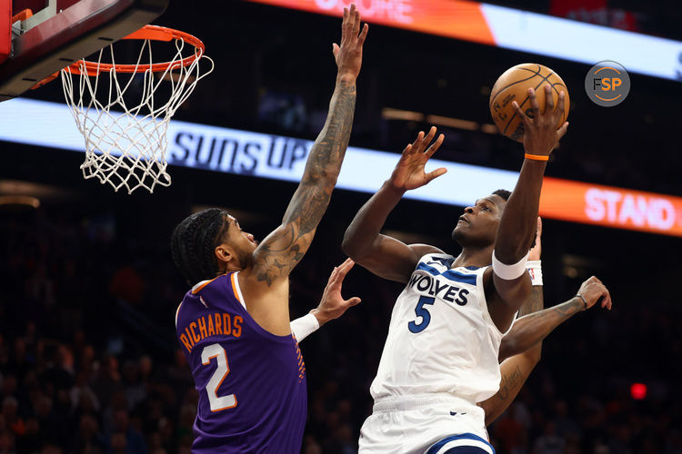 Jan 29, 2025; Phoenix, Arizona, USA; Minnesota Timberwolves guard Anthony Edwards (5) shoots the ball over Phoenix Suns center Nick Richards (2) in the first half at Footprint Center. Credit: Mark J. Rebilas-Imagn Images