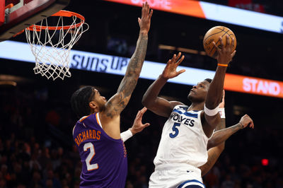 Jan 29, 2025; Phoenix, Arizona, USA; Minnesota Timberwolves guard Anthony Edwards (5) shoots the ball over Phoenix Suns center Nick Richards (2) in the first half at Footprint Center. Mandatory Credit: Mark J. Rebilas-Imagn Images