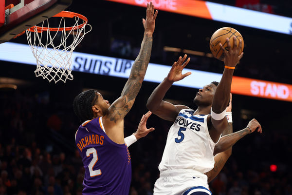 Jan 29, 2025; Phoenix, Arizona, USA; Minnesota Timberwolves guard Anthony Edwards (5) shoots the ball over Phoenix Suns center Nick Richards (2) in the first half at Footprint Center. Mandatory Credit: Mark J. Rebilas-Imagn Images