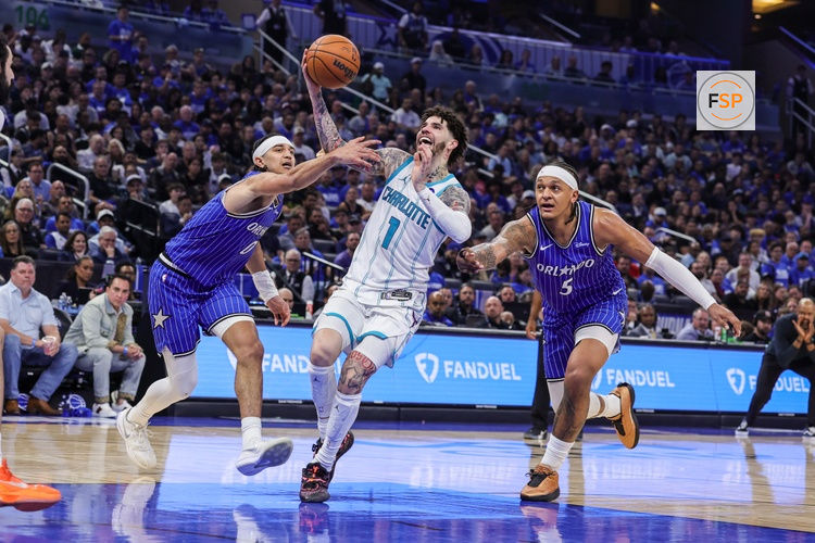 Apr 17, 2026; Orlando, Florida, USA; Charlotte Hornets guard LaMelo Ball (1) is fouled by Orlando Magic guard Anthony Black (0) during the second half during the play-in rounds of the 2026 NBA Playoffs at Kia Center. Credit: Mike Watters-Imagn Images