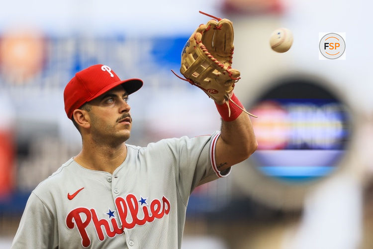 Aug 11, 2025; Cincinnati, Ohio, USA; Philadelphia Phillies third baseman Otto Kemp (4) catches a ball as he walks off the field at the end of the third inning in the game against the Cincinnati Reds at Great American Ball Park. Credit: Katie Stratman-Imagn Images