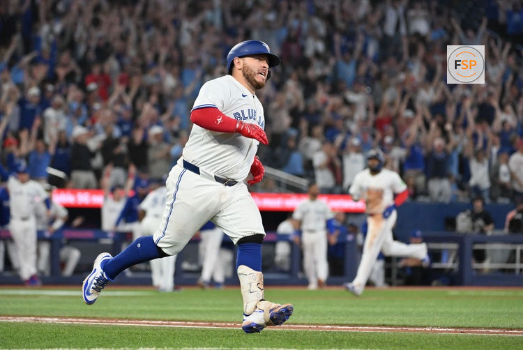 Jun 4, 2025; Toronto, Ontario, CAN;  Toronto Blue Jays catcher Alejandro Kirk (30) hits a walkoff RBI double against the Philadelphia Phillies in the ninth inning at Rogers Centre. Credit: Dan Hamilton-Imagn Images
