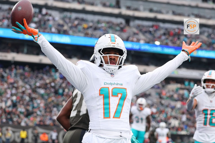 Dec 7, 2025; East Rutherford, New Jersey, USA; Miami Dolphins wide receiver Jaylen Waddle (17) reacts after making a catch for a touchdown against the New York Jets during the first half at MetLife Stadium. Credit: Ed Mulholland-Imagn Images