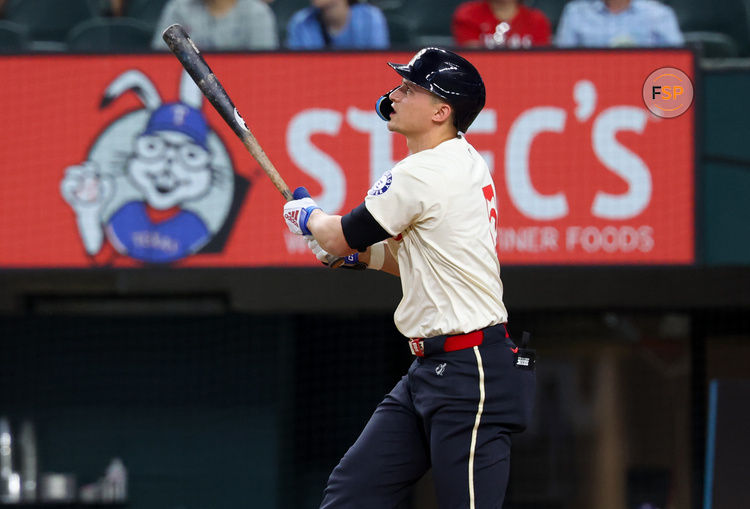 Aug 2, 2024; Arlington, Texas, USA; Texas Rangers shortstop Corey Seager (5) hits a home run during the first inning against the Boston Red Sox at Globe Life Field. Credit: Kevin Jairaj-USA TODAY Sports
