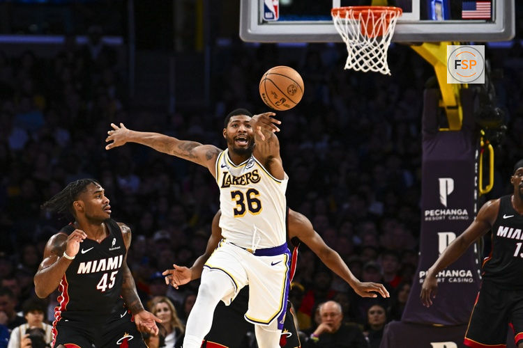 Nov 2, 2025; Los Angeles, California, USA; Los Angeles Lakers guard Marcus Smart (36) passes the ball against Miami Heat guard Davion Mitchell (45) during the first half at Crypto.com Arena. Credit: Jonathan Hui-Imagn Images