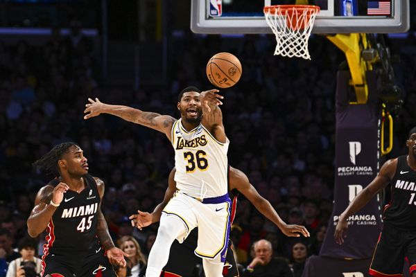 Nov 2, 2025; Los Angeles, California, USA; Los Angeles Lakers guard Marcus Smart (36) passes the ball against Miami Heat guard Davion Mitchell (45) during the first half at Crypto.com Arena. Mandatory Credit: Jonathan Hui-Imagn Images