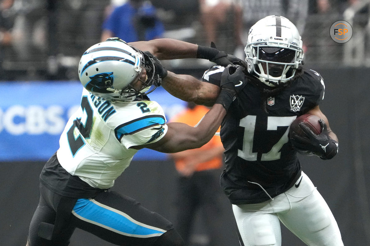 Sep 22, 2024; Paradise, Nevada, USA; Las Vegas Raiders wide receiver Davante Adams (17) carries the ball against Carolina Panthers cornerback Michael Jackson (2) in the first half at Allegiant Stadium. Credit: Kirby Lee-Imagn Images