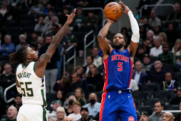 Nov 13, 2024; Milwaukee, Wisconsin, USA;  Detroit Pistons guard Malik Beasley (5) shoots against Milwaukee Bucks guard Delon Wright (55) during the third quarter at Fiserv Forum. Mandatory Credit: Jeff Hanisch-Imagn Images