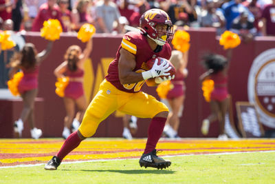 Sep 15, 2024; Landover, Maryland, USA;  Washington Commanders running back Austin Ekeler (30) receives the opening kickoff in the first quarter against the New York Giants at Commanders Field. Mandatory Credit: Luke Johnson-Imagn Images

