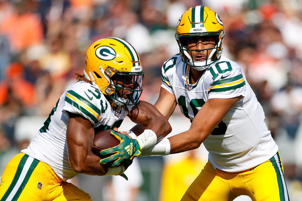 CHICAGO, IL - SEPTEMBER 10: Green Bay Packers quarterback Jordan Love (10) hands the ball off to running back Aaron Jones (33) in the first quarter during a regular season game between the Green Bay Packers and the Chicago Bears on September, 10, 2023, at Soldier Field in Chicago, IL. (Photo by Brandon Sloter/Icon Sportswire)