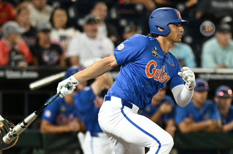 Jun 19, 2024; Omaha, NE, USA;  Florida Gators first baseman Jac Caglianone (14) singles in the Texas A&M Aggies during the eighth inning at Charles Schwab Field Omaha. Credit: Steven Branscombe-USA TODAY Sports