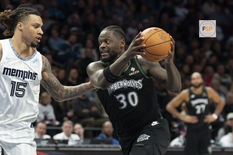 Dec 17, 2025; Minneapolis, Minnesota, USA; Minnesota Timberwolves forward Julius Randle (30) drives to the basket past Memphis Grizzlies forward Brandon Clarke (15) in the second half at Target Center. Credit: Jesse Johnson-Imagn Images
