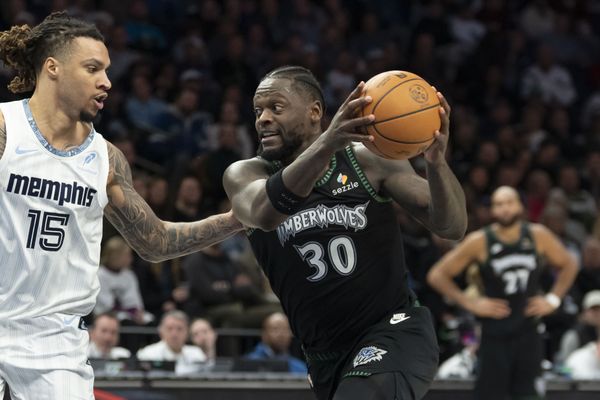 Dec 17, 2025; Minneapolis, Minnesota, USA; Minnesota Timberwolves forward Julius Randle (30) drives to the basket past Memphis Grizzlies forward Brandon Clarke (15) in the second half at Target Center. Mandatory Credit: Jesse Johnson-Imagn Images