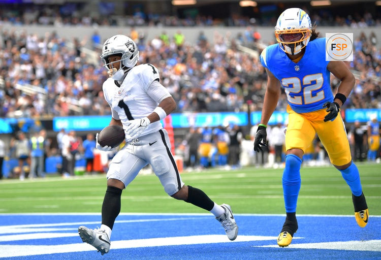 Sep 20, 2026; Inglewood, California, USA;  Las Vegas Raiders wide receiver Tre Tucker (1) scores a touchdown past Los Angeles Chargers safety Genesis Smith (22) during the first half at SoFi Stadium.  Credit: Gary A. Vasquez-Imagn Images