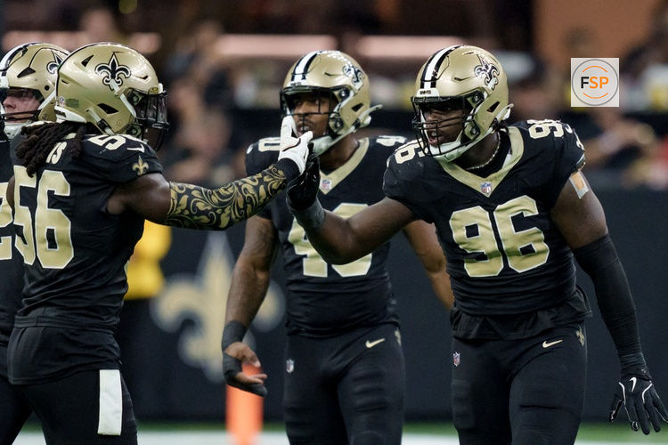 Sep 14, 2025; New Orleans, Louisiana, USA; New Orleans Saints defensive end Carl Granderson (96) reacts after tackling San Francisco 49ers quarterback Mac Jones (not shown) with linebacker Demario Davis (56) during the first half at Caesars Superdome. Credit: Matthew Hinton-Imagn Images