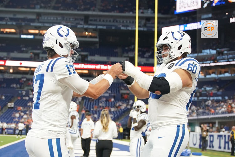 Sep 14, 2025; Indianapolis, Indiana, USA; Indianapolis Colts quarterback Daniel Jones (17) and center Tanor Bortolini (60) warm up prior to the game against the Denver Broncos at Lucas Oil Stadium. Credit: Robert Goddin-Imagn Images