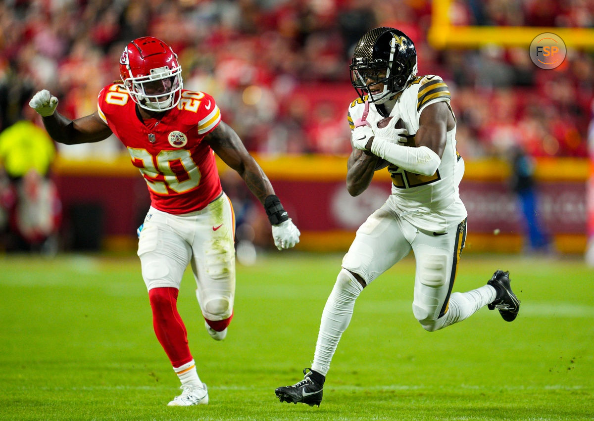 Oct 7, 2024; Kansas City, Missouri, USA; New Orleans Saints wide receiver Rashid Shaheed (22) runs with the ball  against Kansas City Chiefs safety Justin Reid (20) during the second half at GEHA Field at Arrowhead Stadium. Credit: Jay Biggerstaff-Imagn Images