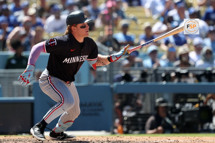 Jul 23, 2025; Los Angeles, California, USA;  Minnesota Twins pinch hitter Harrison Bader (12) hits an RBI single during the eighth inning against the Los Angeles Dodgers at Dodger Stadium. Credit: Kiyoshi Mio-Imagn Images