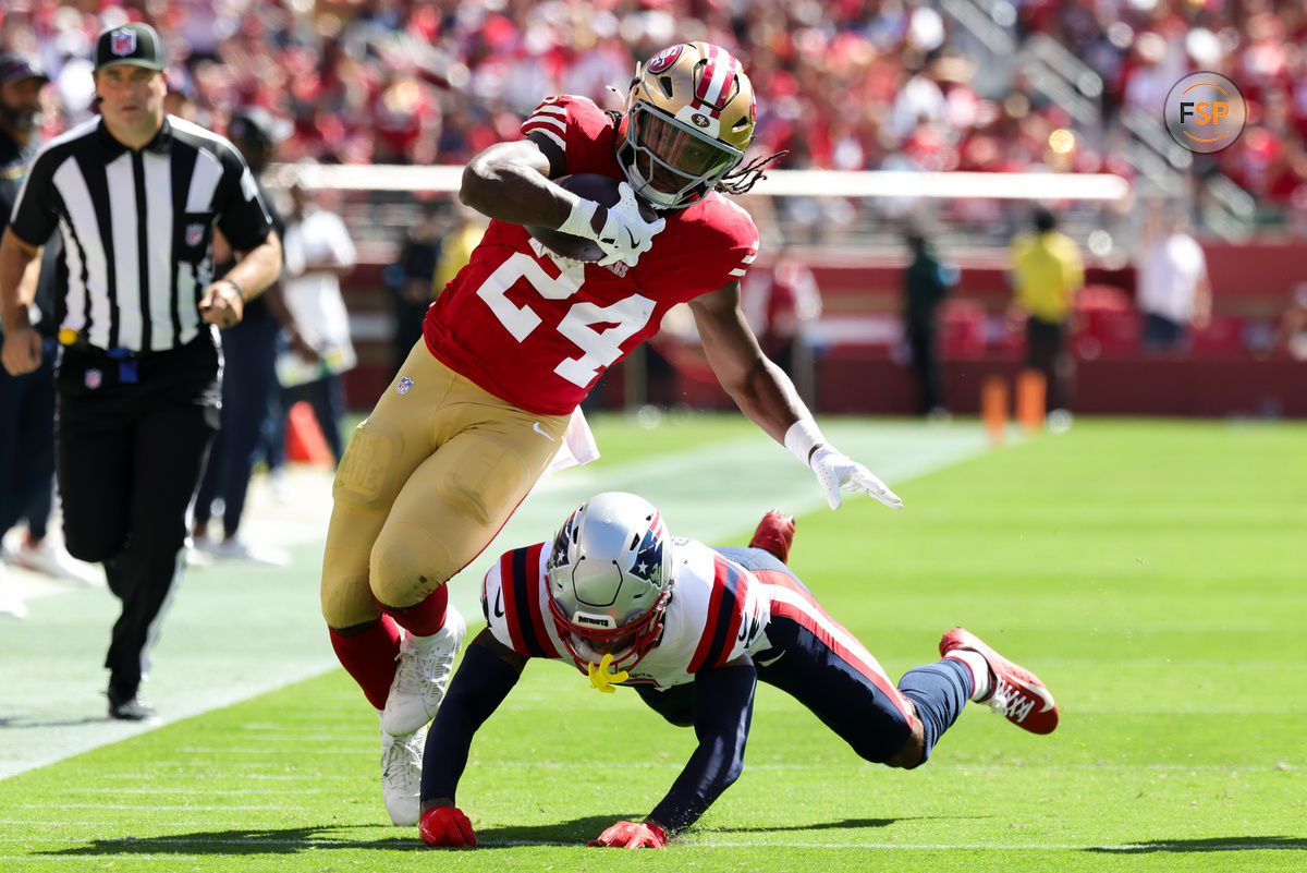 Sep 29, 2024; Santa Clara, California, USA; San Francisco 49ers running back Jordan Mason (24) is tackled by New England Patriots cornerback Christian Gonzalez (0) during the first quarter at Levi's Stadium. Credit: Sergio Estrada-Imagn Images