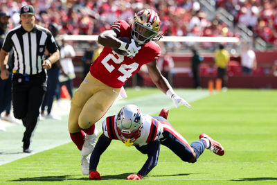 Sep 29, 2024; Santa Clara, California, USA; San Francisco 49ers running back Jordan Mason (24) is tackled by New England Patriots cornerback Christian Gonzalez (0) during the first quarter at Levi's Stadium. Mandatory Credit: Sergio Estrada-Imagn Images