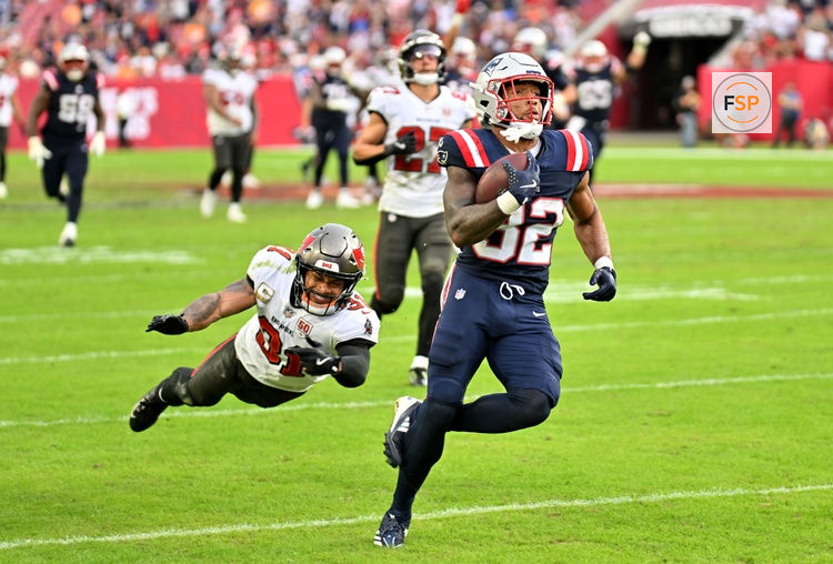 Nov 9, 2025; Tampa, Florida, USA; New England Patriots running back Treveyon Henderson (32) runs for a touchdown past Tampa Bay Buccaneers cornerback Josh Hayes (32) during the third quarter at Raymond James Stadium. Credit: Jonathan Dyer-Imagn Images