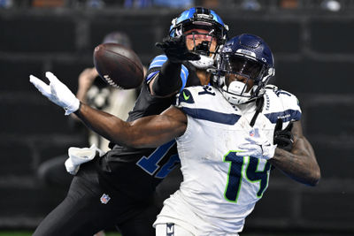 Sep 30, 2024; Detroit, Michigan, USA;  Detroit Lions safety Brandon Joseph (12) breaks up a pass in the end zone intended for Seattle Seahawks wide receiver DK Metcalf (14) in the fourth quarter at Ford Field. Mandatory Credit: Lon Horwedel-Imagn Images