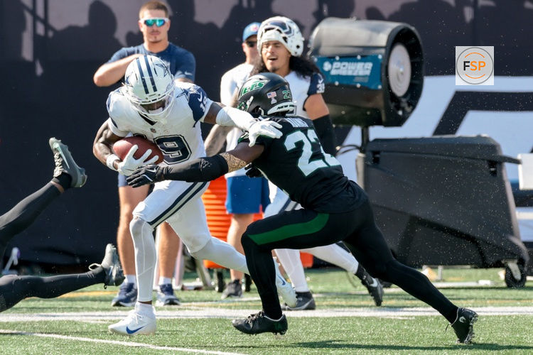 Oct 5, 2025; East Rutherford, New Jersey, USA; Dallas Cowboys wide receiver Ryan Flournoy (19) runs after the catch as New York Jets safety Tony Adams (22) defends during the first half at MetLife Stadium. Credit: Vincent Carchietta-Imagn Images