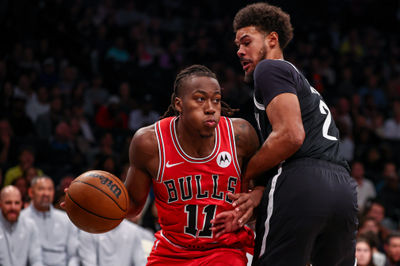 Nov 1, 2024; Brooklyn, New York, USA; Chicago Bulls guard Ayo Dosunmu (11) dribbles against Brooklyn Nets forward Dorian Finney-Smith (28) during the first half at Barclays Center. Mandatory Credit: Vincent Carchietta-Imagn Images