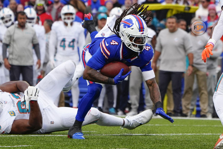 Nov 3, 2024; Orchard Park, New York, USA; Buffalo Bills running back James Cook (4) runs with the ball against the Miami Dolphins during the second half at Highmark Stadium. Credit: Gregory Fisher-Imagn Images