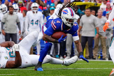 Nov 3, 2024; Orchard Park, New York, USA; Buffalo Bills running back James Cook (4) runs with the ball against the Miami Dolphins during the second half at Highmark Stadium. Mandatory Credit: Gregory Fisher-Imagn Images