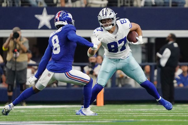 Sep 14, 2025; Arlington, Texas, USA; Dallas Cowboys tight end Jake Ferguson (87) runs with the ball against New York Giants safety Jevon Holland (8) during the second quarter at AT&T Stadium. Mandatory Credit: Raymond Carlin III-Imagn Images