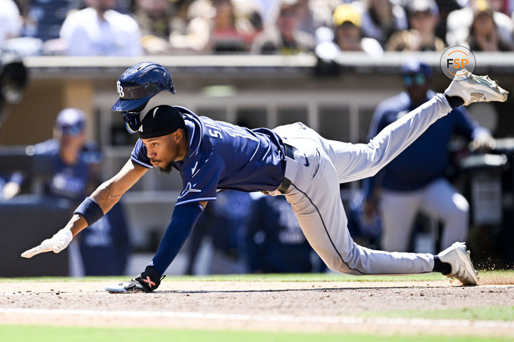 Apr 27, 2025; San Diego, California, USA; Tampa Bay Rays shortstop Chandler Simpson (14) dives to score on a wild pitch during the fifth inning against the San Diego Padres at Petco Park. Credit: Denis Poroy-Imagn Images
