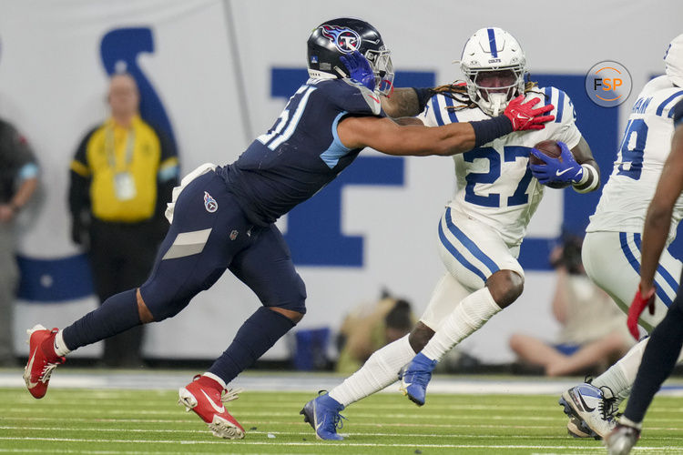 Dec 22, 2024; Indianapolis, Indiana, USA; Tennessee Titans linebacker Cedric Gray (51) reaches for Indianapolis Colts running back Trey Sermon (27) during a game against the Tennessee Titans at Lucas Oil Stadium. Credit: Christine Tannous/USA Today Network via Imagn Images 