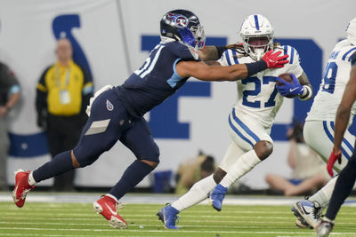 Dec 22, 2024; Indianapolis, Indiana, USA; Tennessee Titans linebacker Cedric Gray (51) reaches for Indianapolis Colts running back Trey Sermon (27) during a game against the Tennessee Titans at Lucas Oil Stadium. Mandatory Credit: Christine Tannous/USA Today Network via Imagn Images 