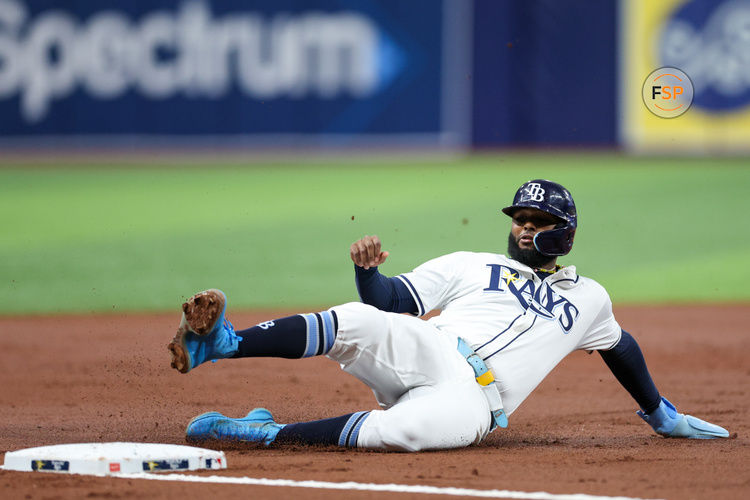 Sep 2, 2024; St. Petersburg, Florida, USA; Tampa Bay Rays third baseman Junior Caminero (13) slide into third base against the Minnesota Twins in the first inning at Tropicana Field. Credit: Nathan Ray Seebeck-USA TODAY Sports