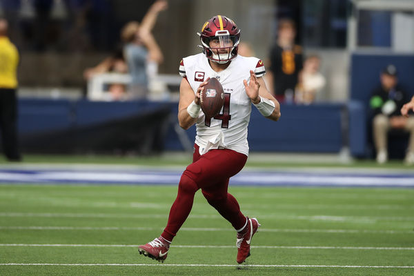 INGLEWOOD, CA - DECEMBER 17: Washington Commanders quarterback Sam Howell (14) rolls out during the NFL game between the Washington Commanders and the Los Angeles Rams on December 17, 2023, at SoFi Stadium in Inglewood, CA. (Photo by Jevone Moore/Icon Sportswire)