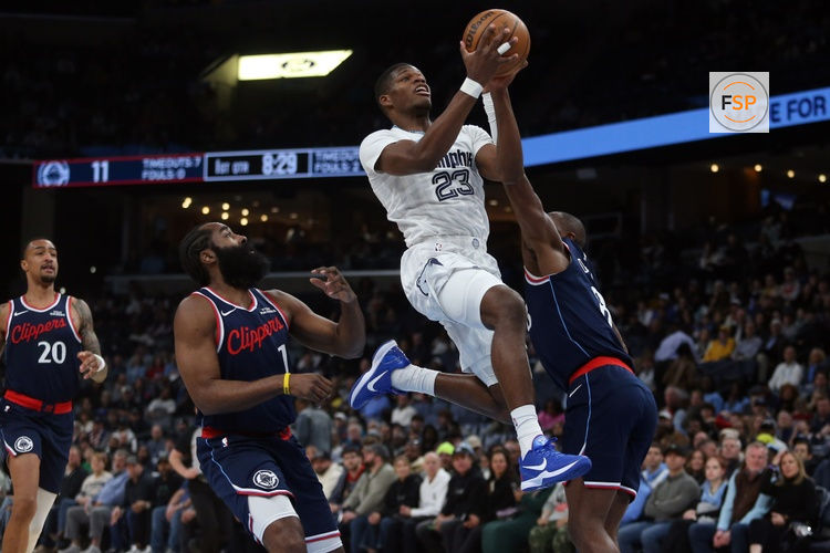 Dec 5, 2025; Memphis, Tennessee, USA; Memphis Grizzlies forward Cedric Coward (23) drives to the basket between guard James Harden (1) and Los Angeles Clippers guard Kris Dunn (8) during the first quarter at FedExForum. Credit: Petre Thomas-Imagn Images