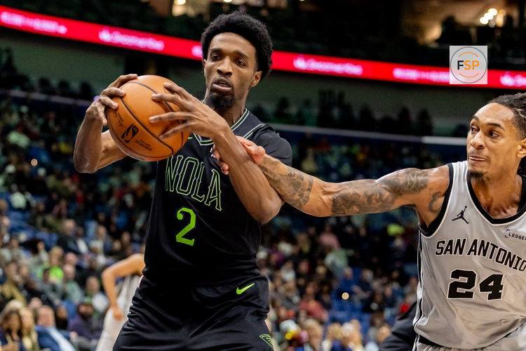 Dec 8, 2025; New Orleans, Louisiana, USA;  San Antonio Spurs guard/forward Devin Vassell (24) fouls New Orleans Pelicans forward Herbert Jones (2) during the first half at Smoothie King Center. Credit: Stephen Lew-Imagn Images